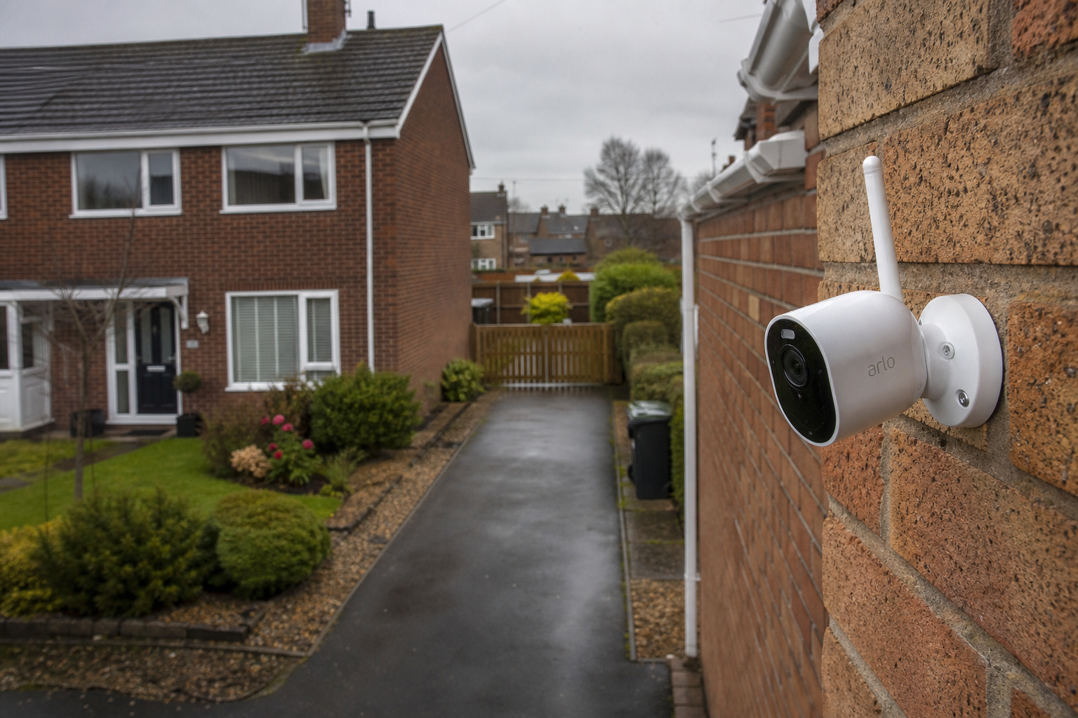 Security camera mounted on a British house overlooking a shared driveway